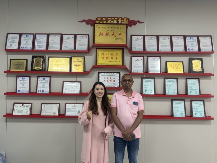 Two visitors standing in front of a display wall