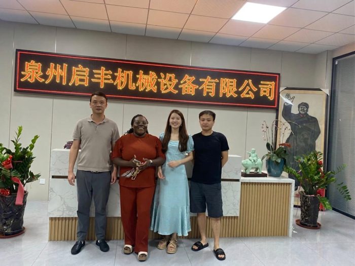 Four visitors standing together at the company reception