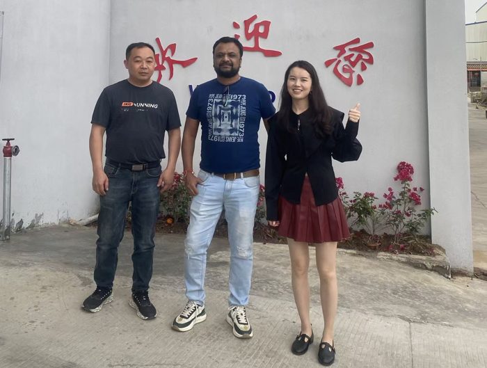 Three visitors standing outside a building