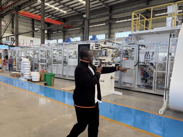 Visitor photographing production machinery in the workshop