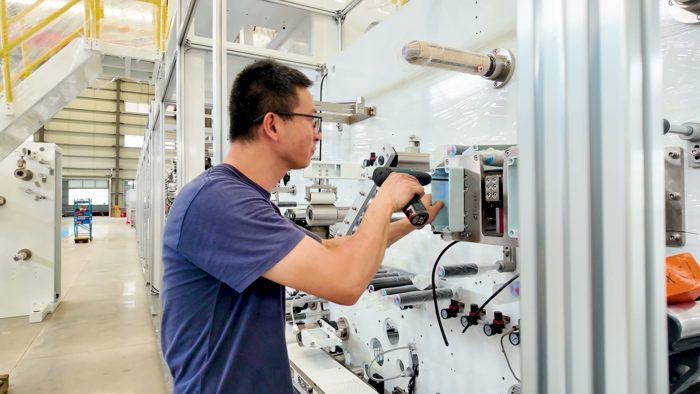 Technician fastening a unit on a production line