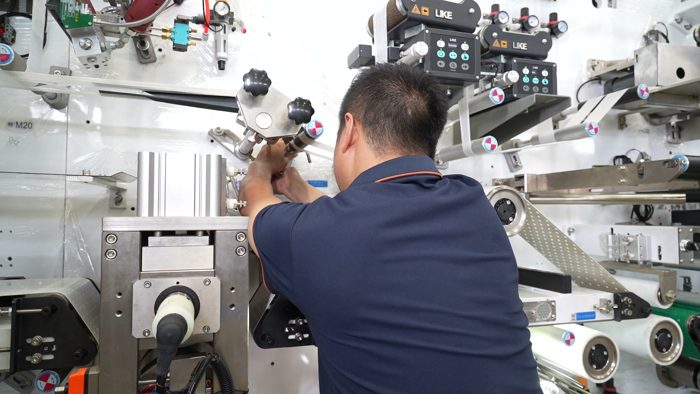 Technician fitting parts to a production machine
