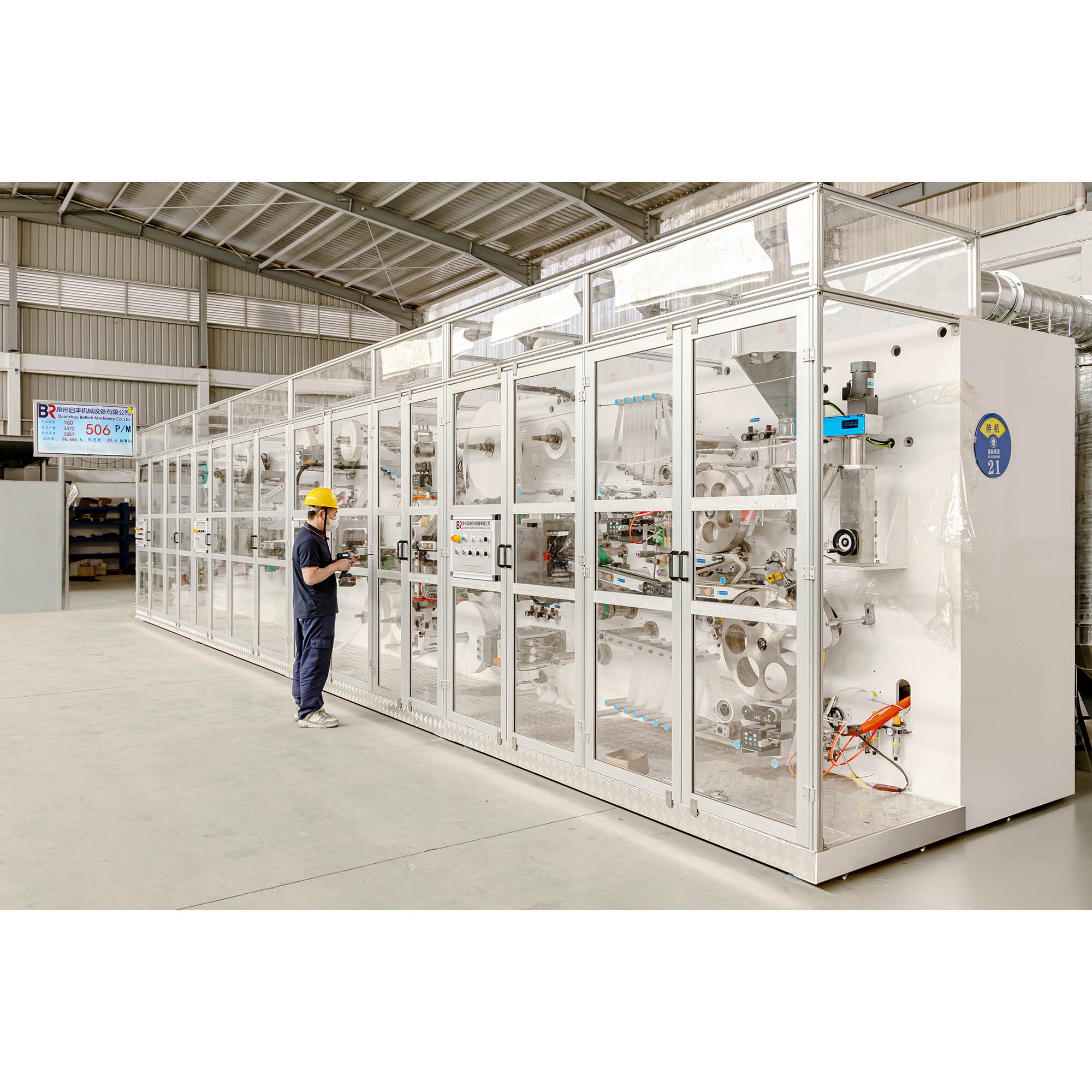 A person checking machinery in the production area